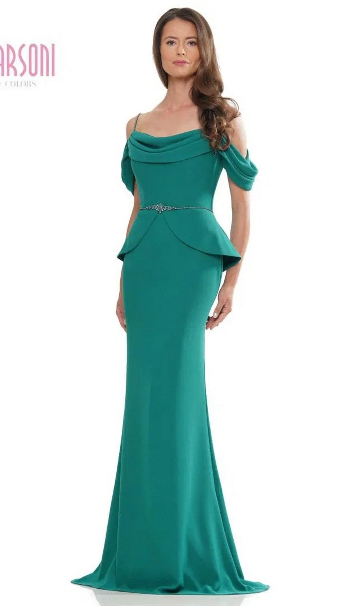 A woman in the Marsoni MV1271 long formal dress in emerald stretch crepe, featuring off-the-shoulder sleeves, a draped neckline, belted waist, and peplum hip detailing.